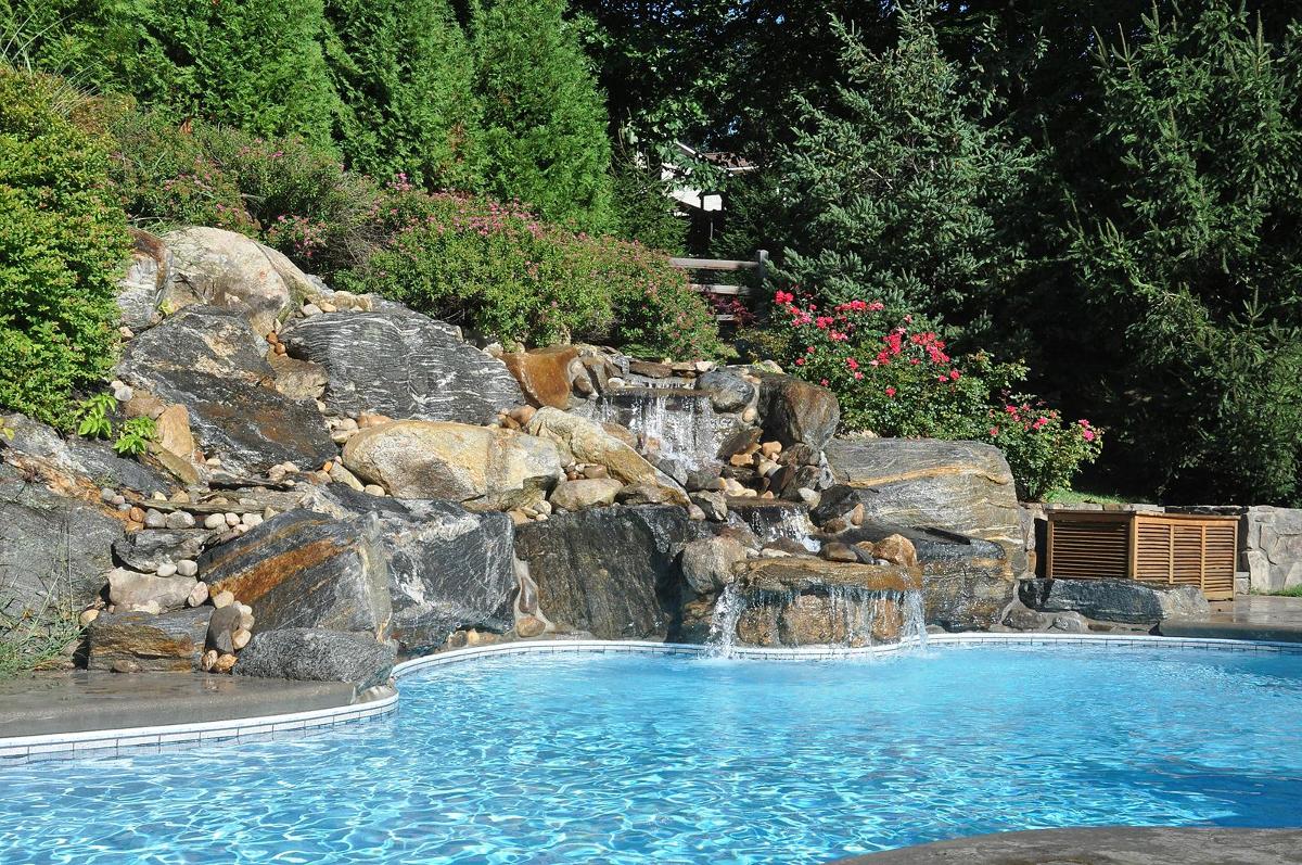 Inground pool with rock fountains