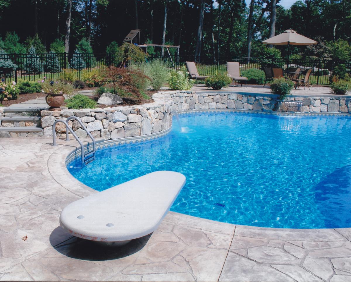 Inground pool with diving board and fountains