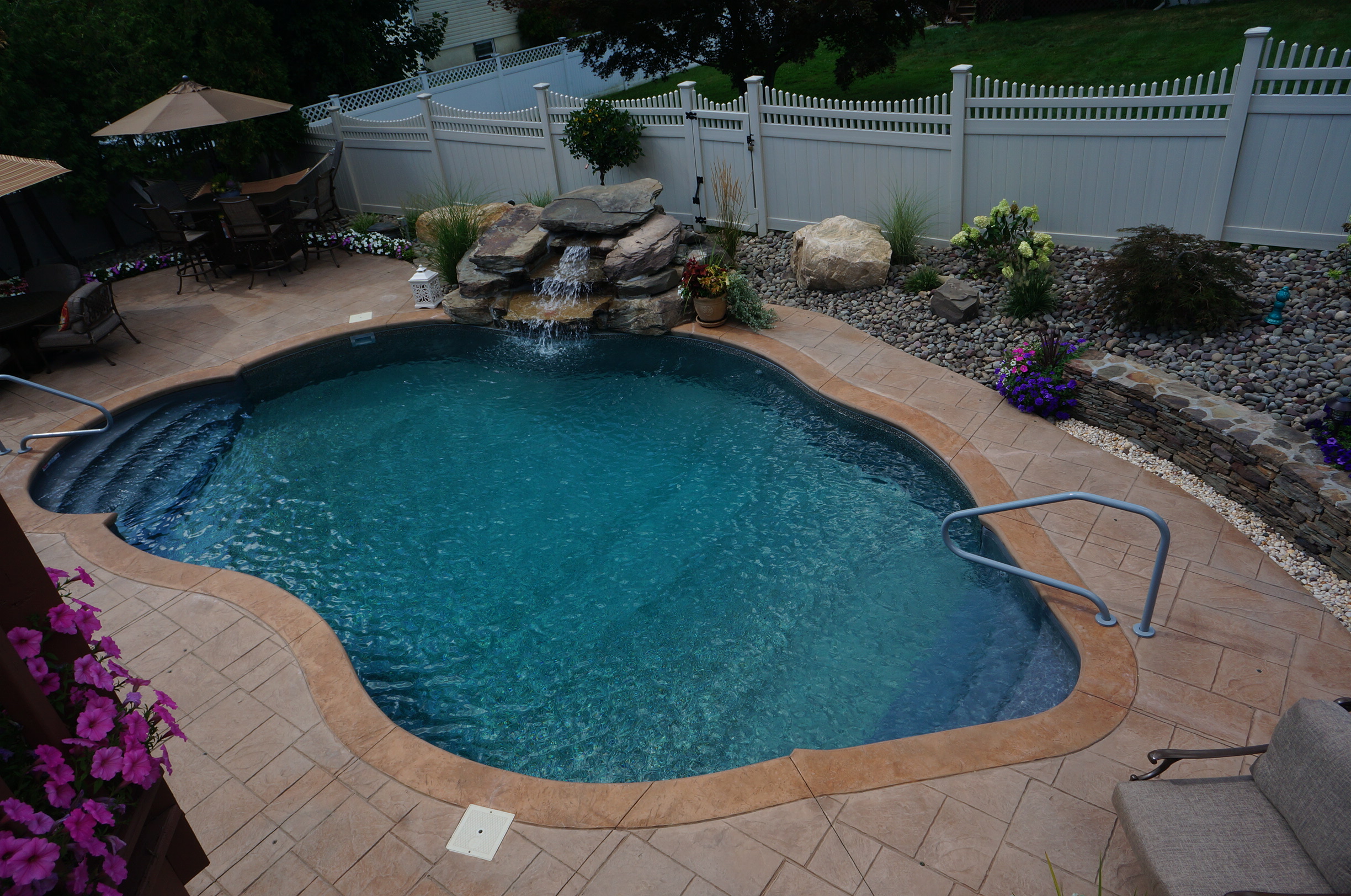 Inground pool with rock fountain